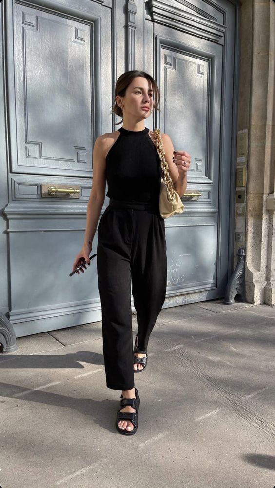 a lovely summer look with a black halter neckline top, cropped pants, dad sandals and a gold bag on chain