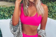 a neon pink swimsuit with a high waisted bottom and a comfy top plus a lovely hat