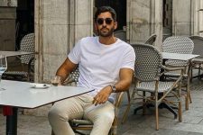 a relaxed summer date outfit with a white t-shirt, tan pants, tan birkenstocks is easy to repeat and looks nice