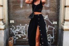 a sexy summer outfit with a crop top, a high waisted midi skirt with buttons, black sneakers and a bag