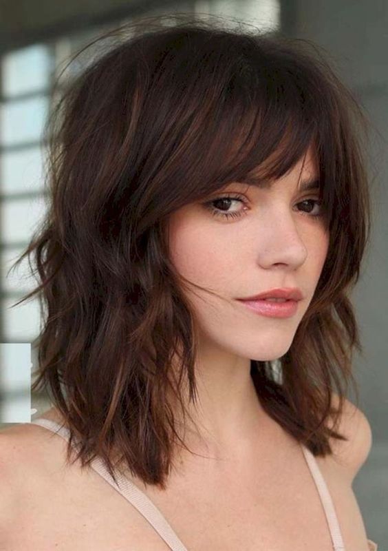 a shaggy dark brown clavicut with French bangs and a bit of waves looks amazing   very messy and very relaxed