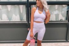 a simple and cute workout look with a lilac co-ord set, a crop top and biker shorts, white sneakers for spring and summer