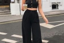 a summer outfit with a black button down crop top, high waisted wideleg pants, white sneakers and layered necklaces