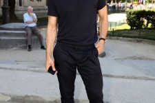a total black look with a t-shirt and pants plus white sneakers to refresh the outfit and make it look cooler