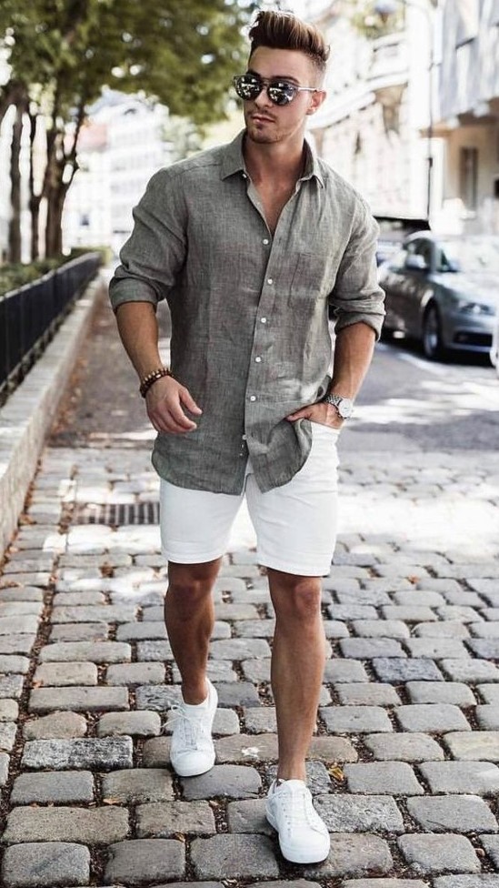 an airy summer outfit with a grey linen shirt, white denim shorts, white sneakers is neutral and chic