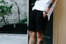 an easy monochromatic summer look with a black and white printed t-shirt, black denim shorts, black socks and high top sneakers