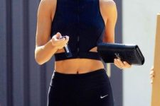 black leggings paired up with a navy halte rneckline cut out crop top look much more interesting than with a usual tee