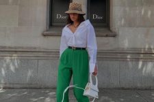 02 a bold and comfortable outfit with an oversized white shirt, green high waisted pants, neutral trainers, a white bag and a bucket hat