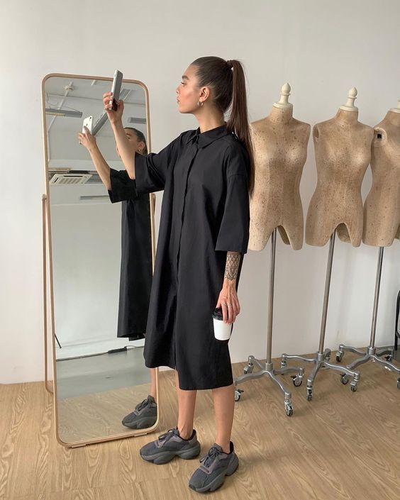 a black midi dress with short sleeves, black and grey trainers are a simple and minimal look for summer