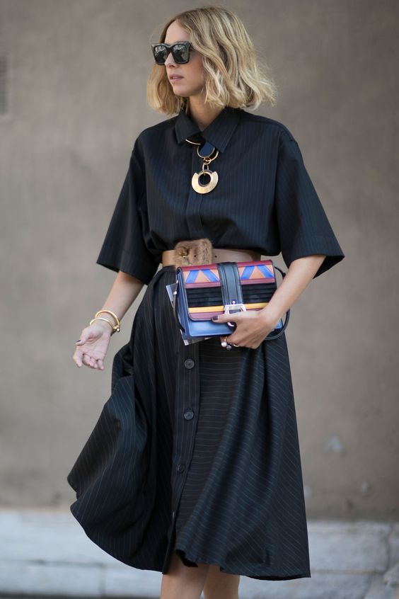 a black midi shirtdress with buttons and thin stripes, short sleeves, a brown belt and a bold clutch for a super refined look at work