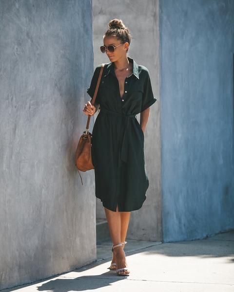 a black midi shirtdress with short sleeves and a deep neckline, a sash, nude shoes and a brown bag for work