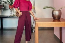 14 a refined monochromatic work look with a fuchsia top with puff sleeves and burgundy pants, silver shoes and a printed bag