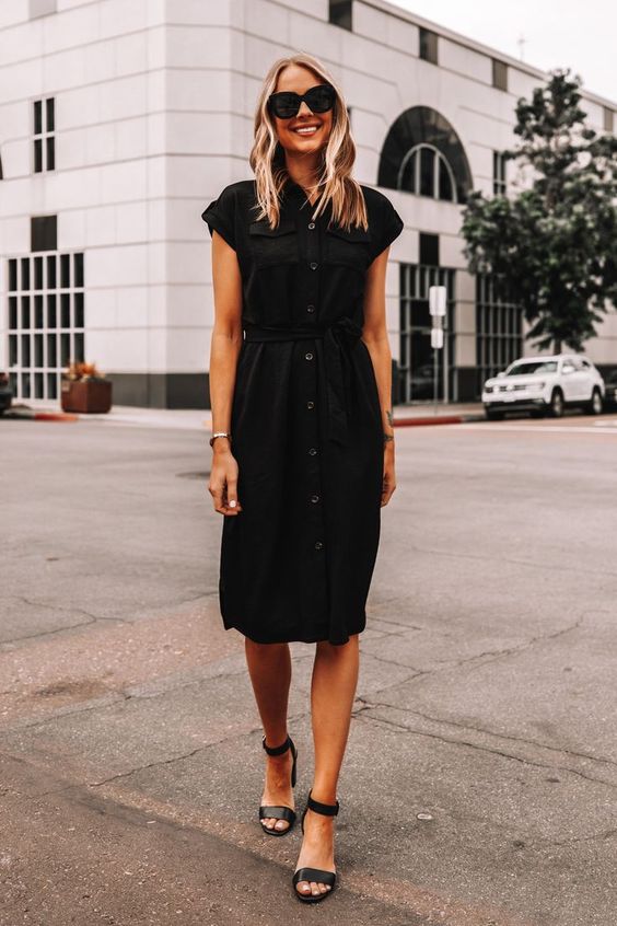 a simple and pretty black shirtdress with cap sleeves and a row of buttons, black ankle strap shoes is cool