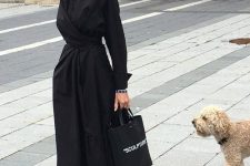 15 a stylish black midi shirtdress with a wraped skirt, black sneakers and a printed tote for a bold look