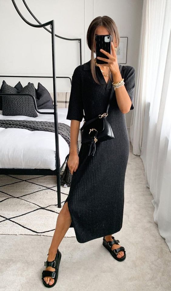a black midi dress with short sleeves, side slits, black dad sandals and black leather bags