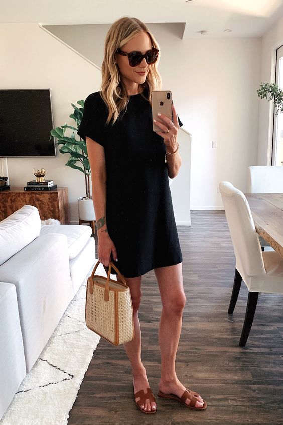 a black mini t-shirt dress with short sleeves, a woven bag and brown slides is a lovely casual look