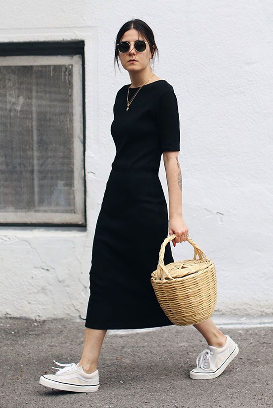 a minimalist look with a black A-line t-shirt midi dress with short sleeves, white snakers and a basket bag