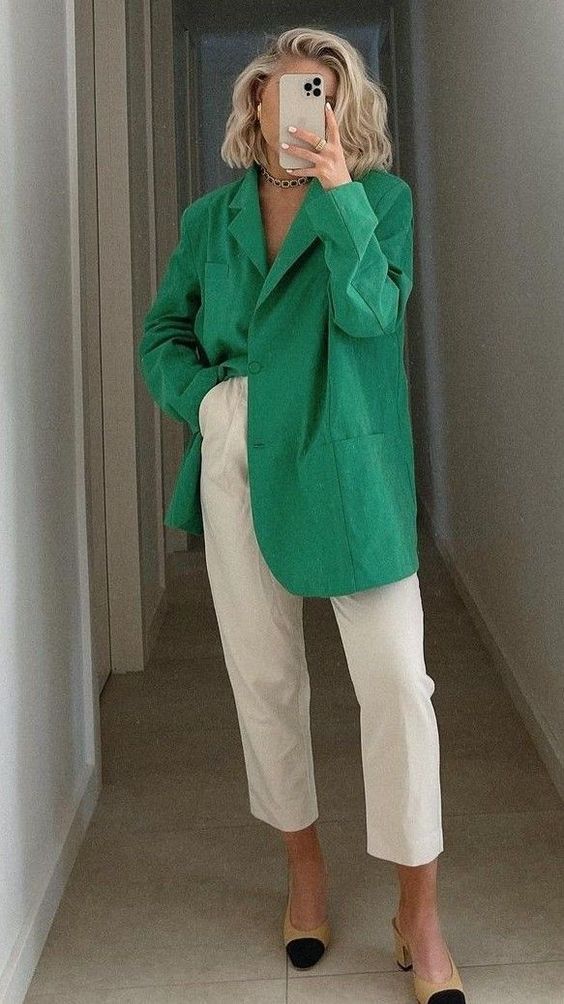 white cropped pants, an oversized apple green blazer and two-tone shoes plus a necklace