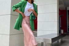 24 a bold work look with a white t-shirt, a blush slip midi skirt, green and white trainers, a green blazer and a green bag