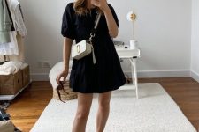 26 a black cotton A-line dress, black birkenstocks and a white bag with a gold logo are a chic combo for every day