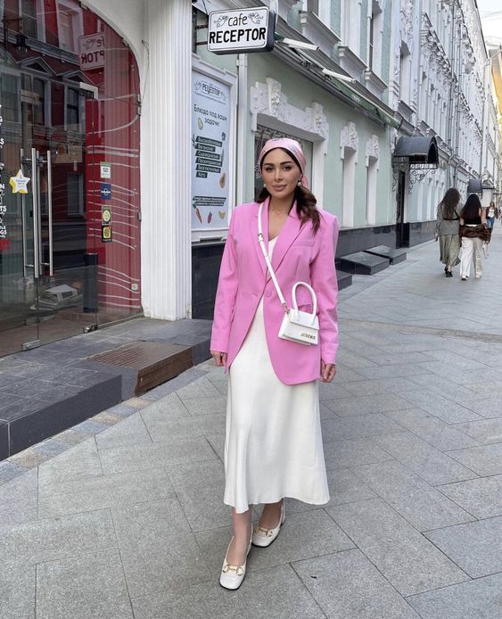 a lovely and elegant summer work look with a neutral slip midi dress, white shoes and a bag and a pink oversized blazer