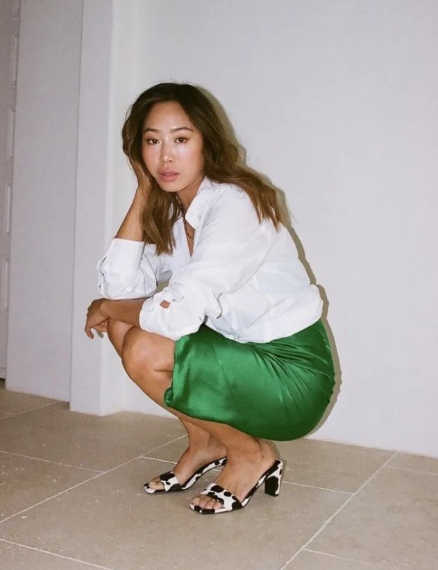 an emerald green slip dress, a white button down, animal print heeled sandals for a bold look at work