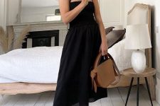 34 a classy and comfy outfit with a black midi dress with ties on the shoulder, black dad sandals and a brown bag is cool