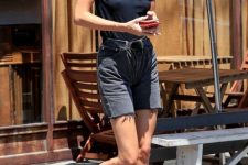 Kendall Jenner wearing a black t-shirt, black denim shorts and a black belt looks simple and very cool