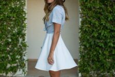 With beige and black wide brim hat, white high-waisted skater mini skirt and light blue platform sandals