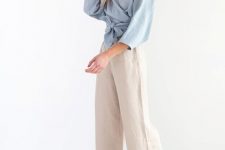 With beige linen culottes and gray suede flat mules