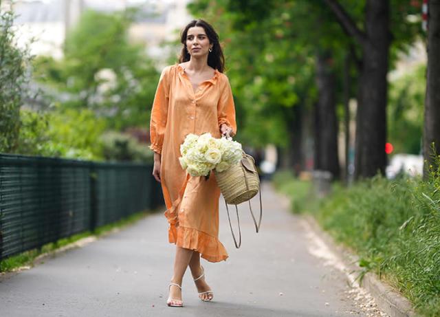 With beige straw bag and white high heels