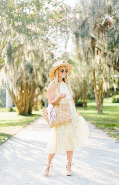 With beige straw wide brim hat, sunglasses, beige tote bag and beige ankle strap shoes