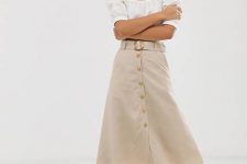 With earrings, white puff sleeved blouse and brown leather lace up low heeled sandals