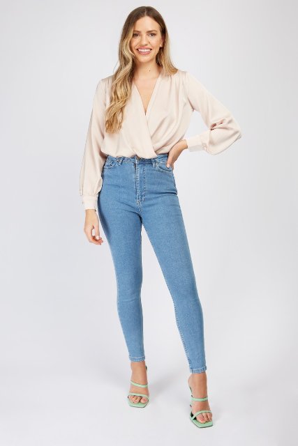 With high-waisted skinny jeans and mint green high heeled sandals