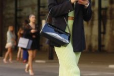 With light green midi skirt, black patent leather bag and white flat shoes