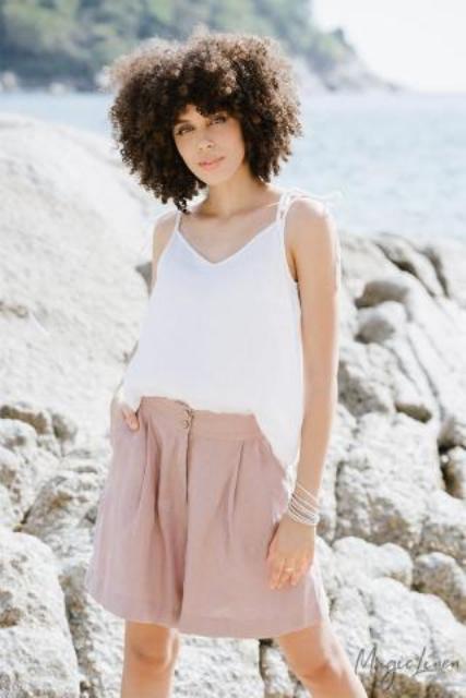 With pale pink linen shorts