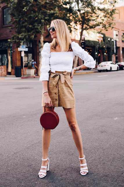 With sunglasses, white puff sleeved shirt, marsala leather rounded bag and white high heeled sandals