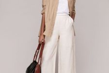 With white loose t-shirt, beige long button down shirt, brown and black leather bag and black lace up flat sandals