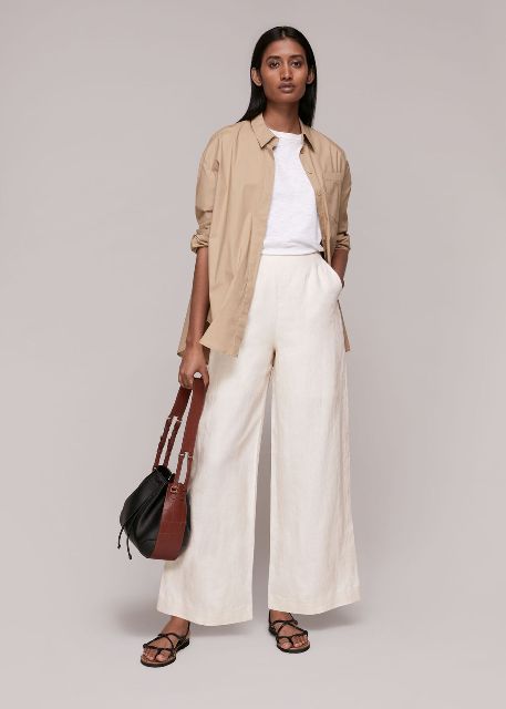 With white loose t-shirt, beige long button down shirt, brown and black leather bag and black lace up flat sandals