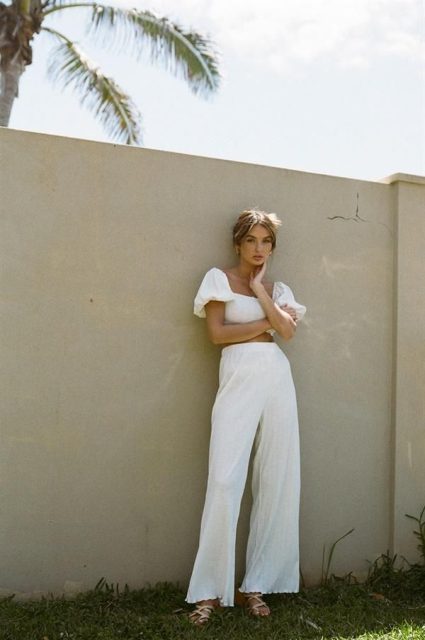 With white puff sleeved crop top and white lace up sandals