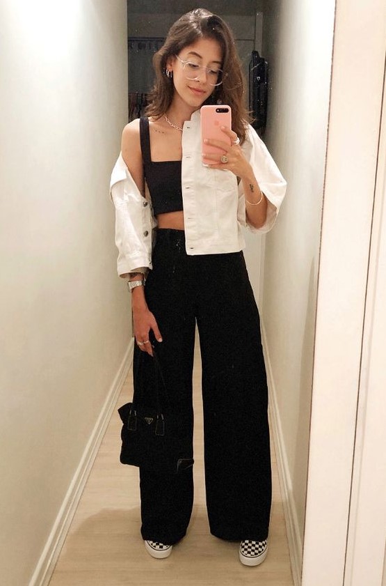 a black crop top and high waisted pants, checked slipons, a white denim cropped jacket and a black bag