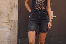 a black summer look with a printed top, ripped black denim shorts, black sneakers is a lovely outfit with a rock feel