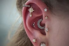 a bold ear set with a double helix, tragus, daith, flat and helix, double lobe piercings with studs and a couple of hoops