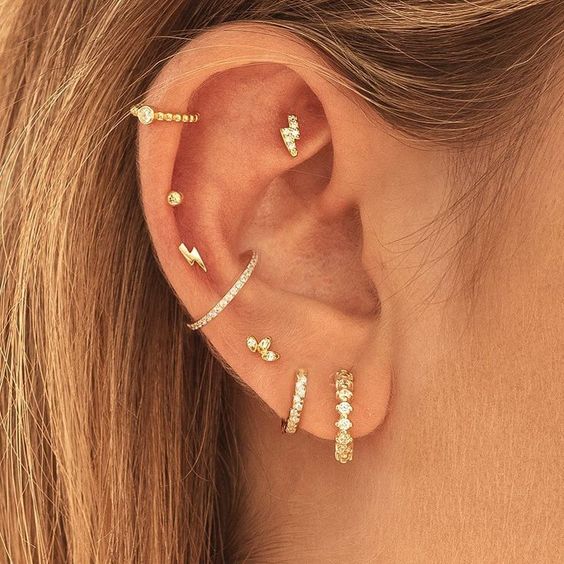 a bold ear with a faux rook, triple helix, conch and triple lobe piercing is a fantastic idea with a bold set