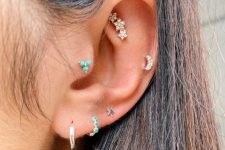 a bright and stylish ear stack with a faux rook, tragus, helix and triple lobe piercing all done with lovely studs and hoops
