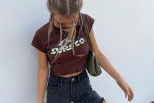 a burgundy printed top, black denim shorts, a green bag and black sneakers for a relaxed teen-inspired outfit