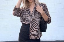 a catchy tan and black zebra print shirt, a black denim mini, a black bag are a lovely combo for summer