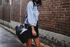 a cold summer day outfit with a bleached denim jacket, a black denim mini, black sneakers and socks, a black bag