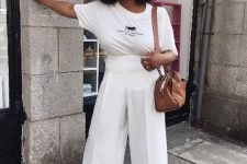 a cool and stylish casual work look with a white printed t-shirt, white wideleg pants, white peep toe shoes and a brown bag