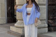 a cool casual outfit with a bra top, high waisted pants, creamy slides, a grey bag and an oversized blue shirt
